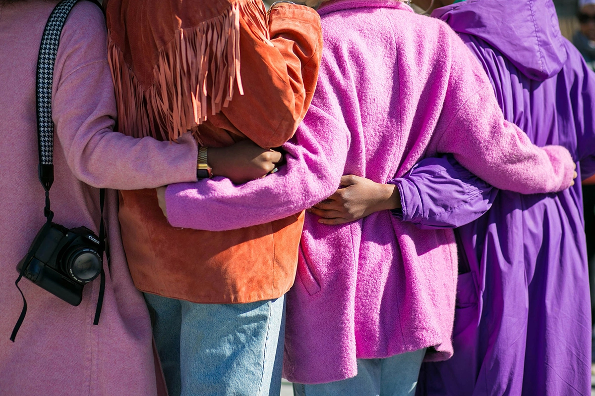 A group of people joining hands in support